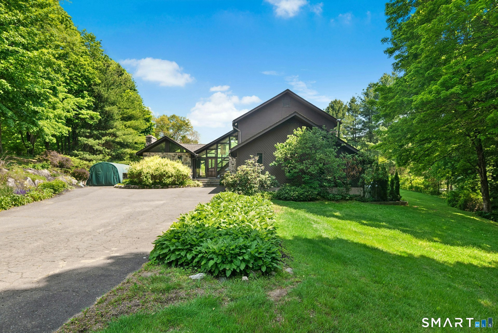 127 Huntingtown Road Newtown, CT 06470 - Photo 2 of 38 a view of a back yard with flower plants and large trees