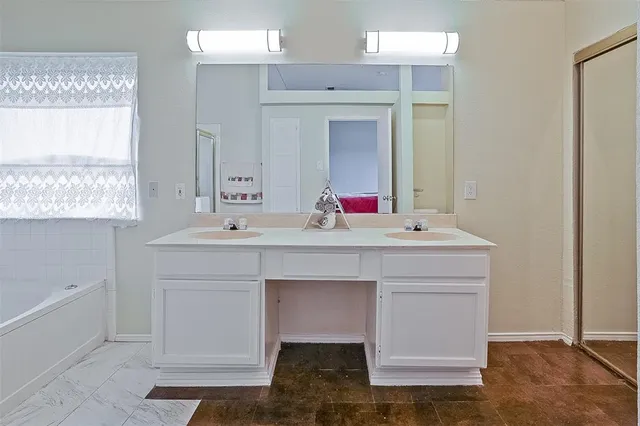 a bathroom with a sink vanity and a mirror