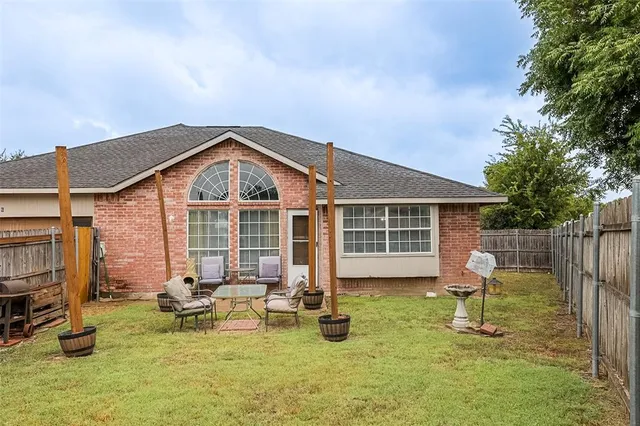 a backyard of a house with yard fire pit and outdoor seating
