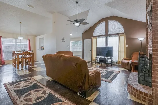 a living room with furniture a chandelier and a flat screen tv