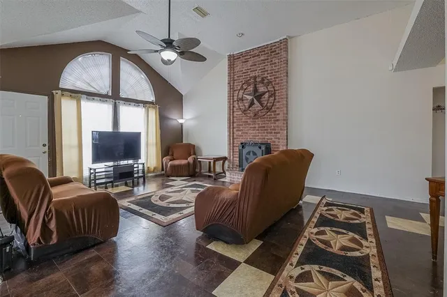 a living room with furniture a flat screen tv and a window
