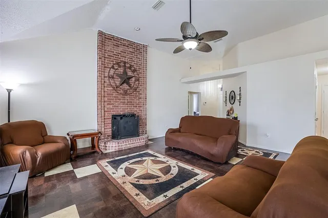 a living room with furniture a fireplace and a chandelier
