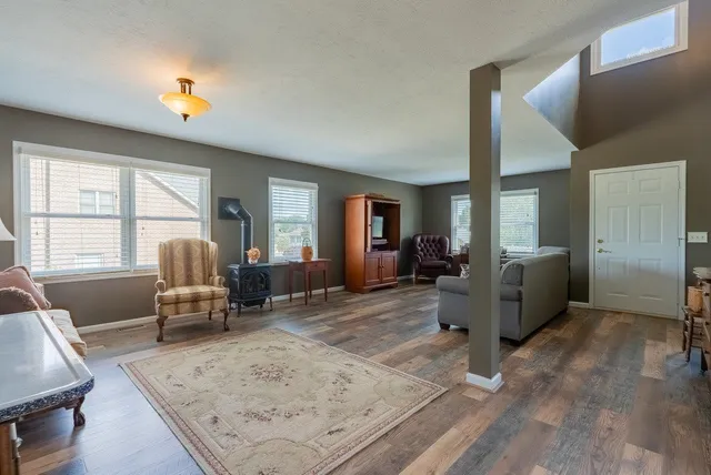 a living room with furniture window and wooden floor