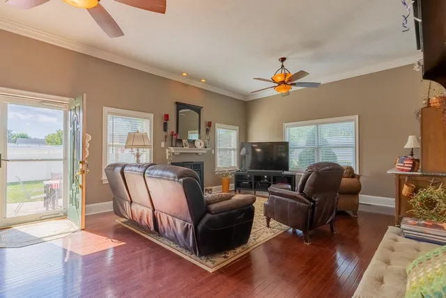 a living room with furniture fireplace and flat screen tv