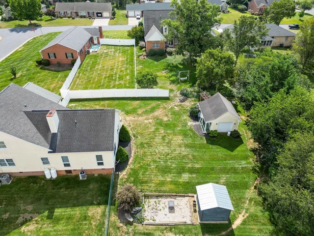 an aerial view of a house with swimming pool garden and patio