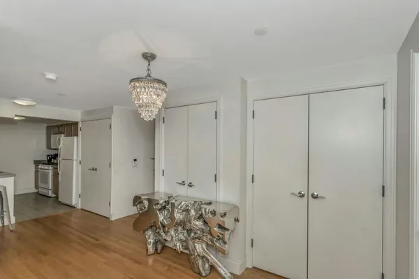 a view of a dining room with furniture wooden floor and chandelier