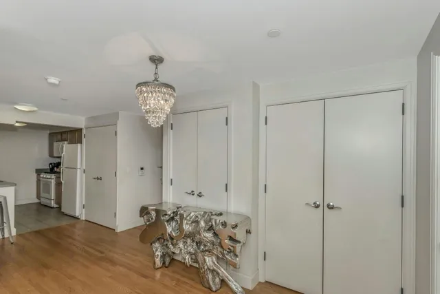 a view of a dining room with furniture wooden floor and chandelier