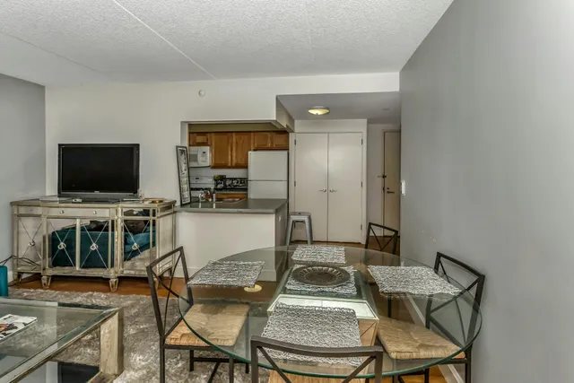 a kitchen with a refrigerator a stove and a sink with wooden floor