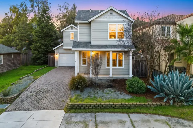 a front view of a house with a garden