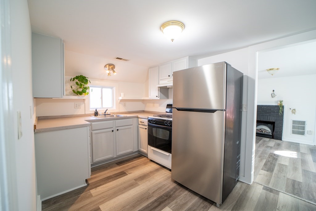 94 Sea Street, Unit B Barnstable, MA 02601 - Photo 2 of 6 a kitchen with a refrigerator and a sink