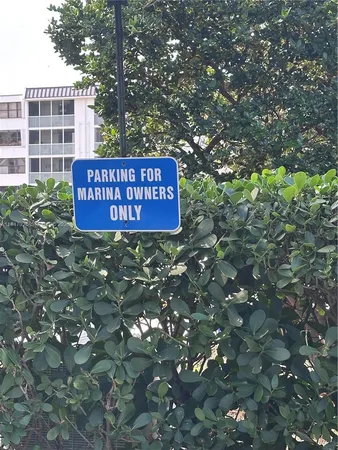 a sign on a tree in front of a building