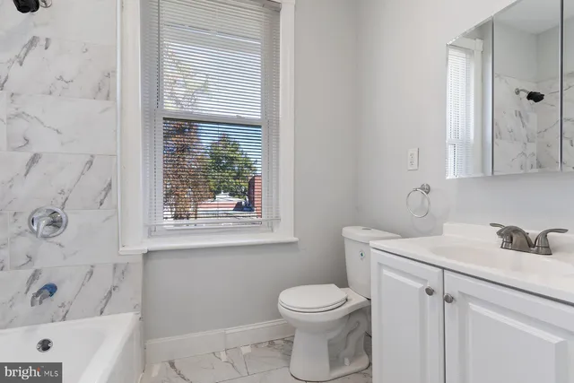 a bathroom with a sink a toilet and a bathtub