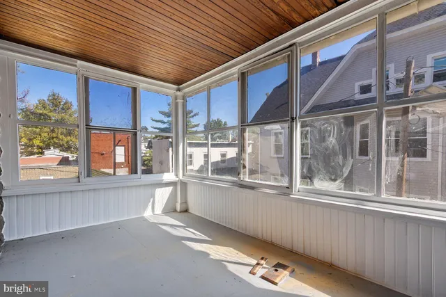 a large room with a large window and furniture