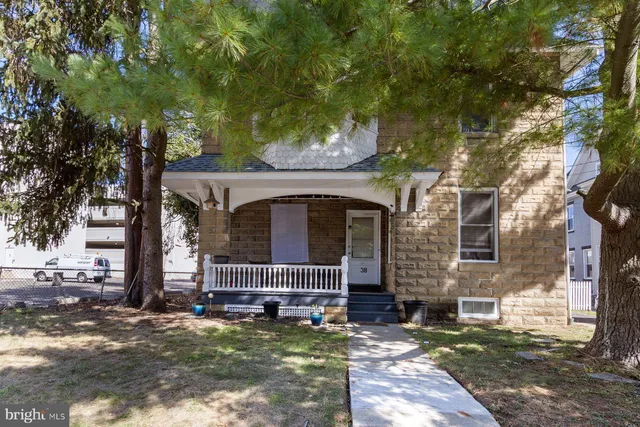 a view of a house with backyard porch and sitting area