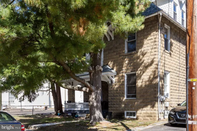 a front view of a building with trees