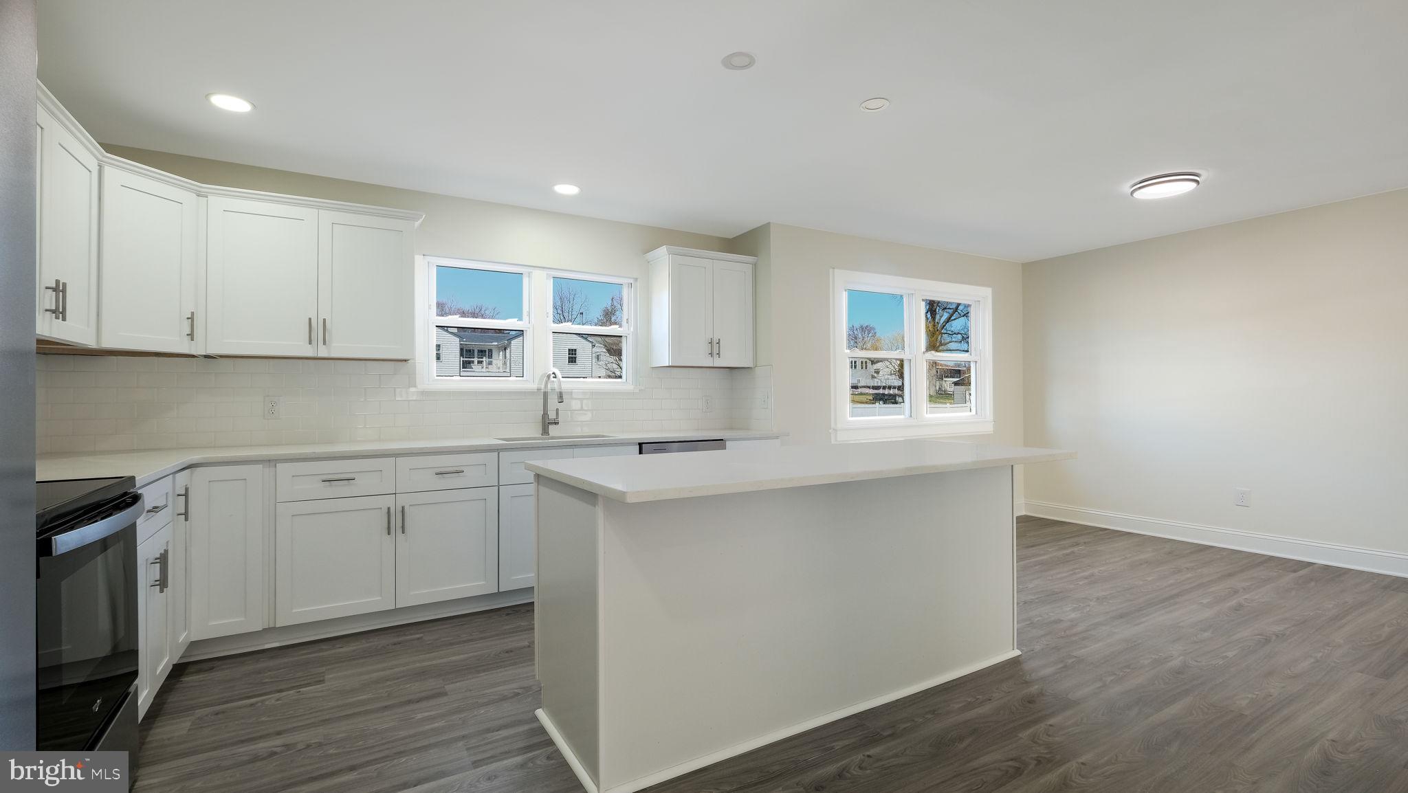 2330 Weir Road Aston, PA 19014 - Photo 11 of 39 a kitchen with granite countertop white cabinets and white appliances