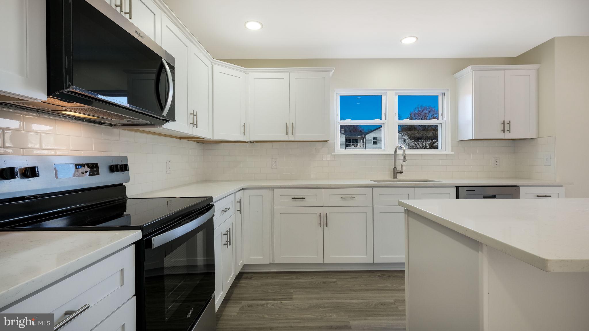2330 Weir Road Aston, PA 19014 - Photo 12 of 39 a kitchen with stainless steel appliances granite countertop a sink stove microwave and cabinets