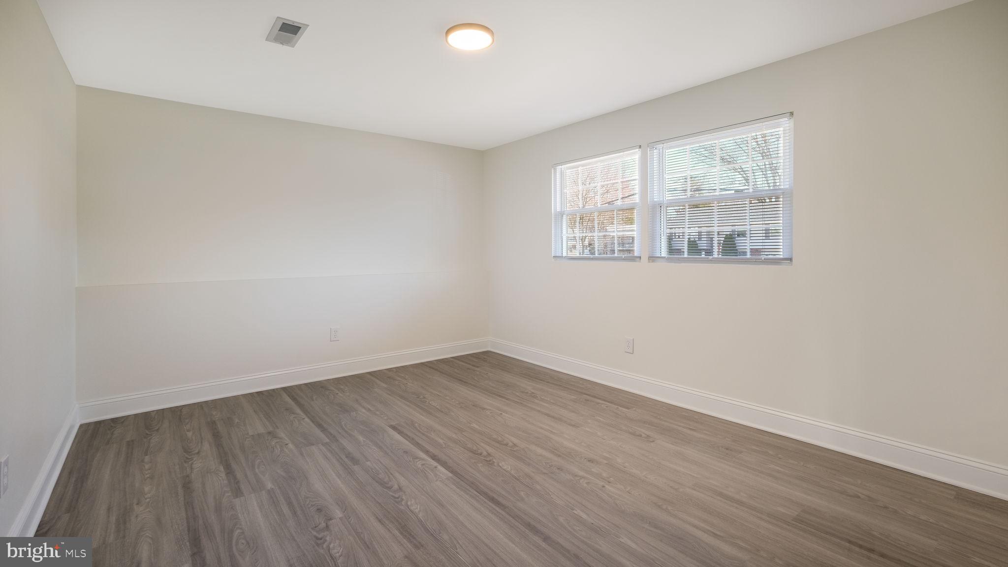 2330 Weir Road Aston, PA 19014 - Photo 27 of 39 an empty room with wooden floor and windows