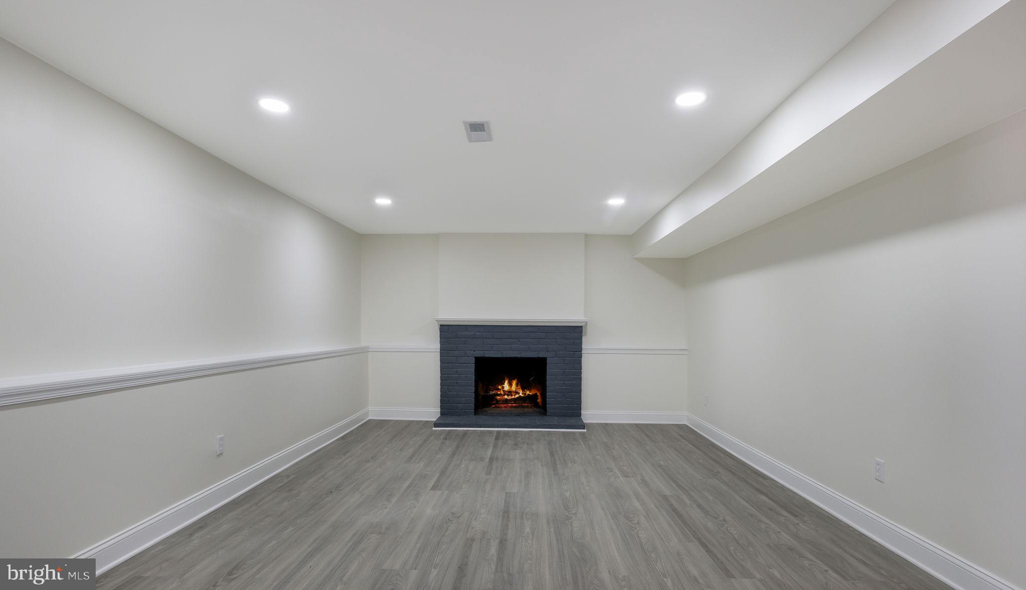 2330 Weir Road Aston, PA 19014 - Photo 29 of 39 a view of an empty room with wooden floor fireplace and a window