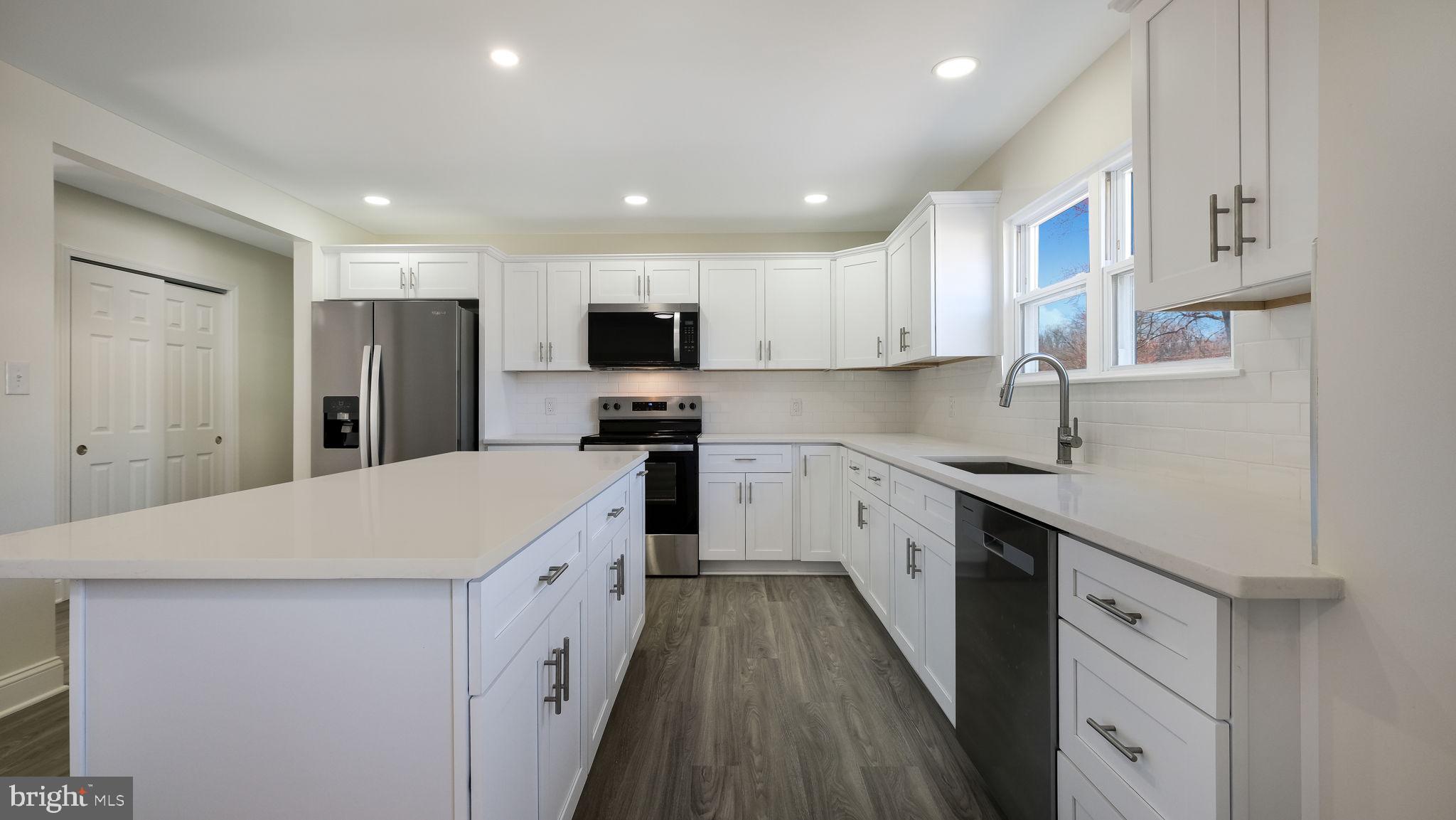 2330 Weir Road Aston, PA 19014 - Photo 8 of 39 a kitchen with white cabinets appliances and sink