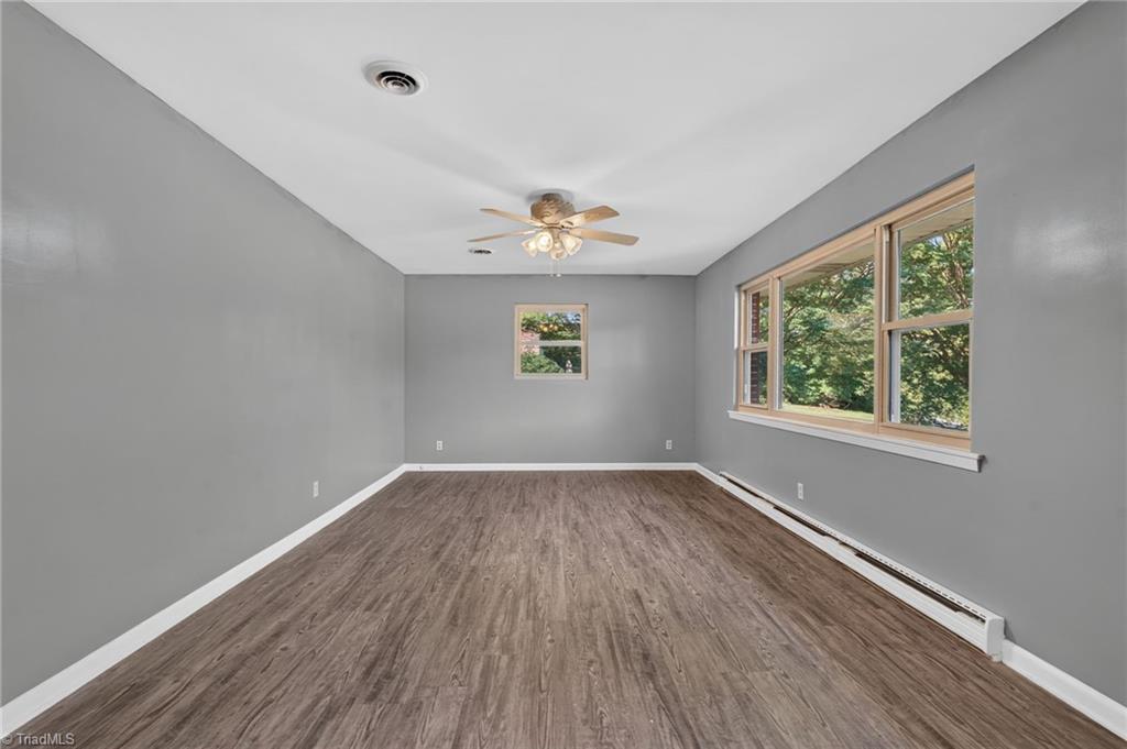 113 Green Valley Road Greensboro, NC 27403 - Photo 12 of 46 Oversized windows frame peaceful views of mature trees, bringing the beauty of Starmount Forest indoors.