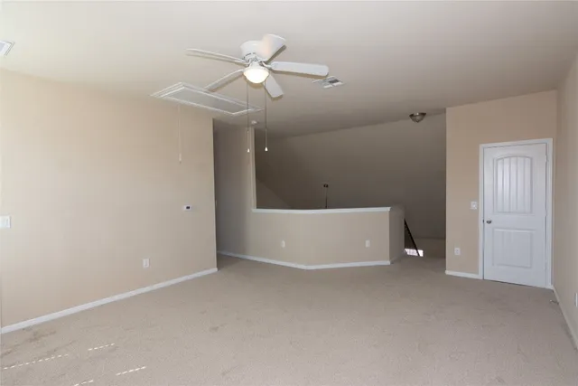 an empty room with fan and window