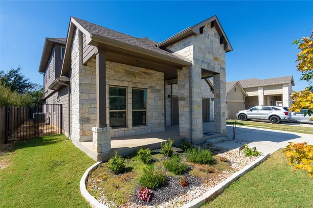 a front view of a house with garden