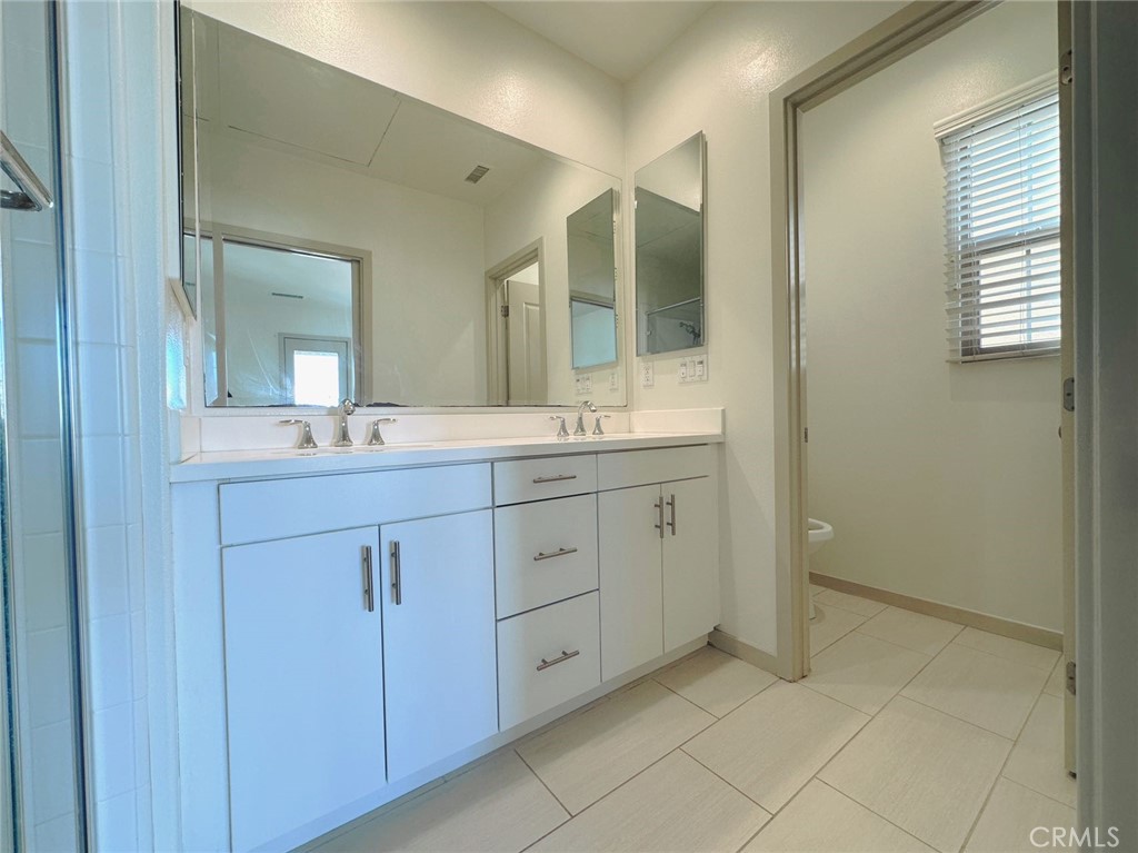 87 Evening Sun Irvine, CA 92620 - Photo 13 of 20 a spacious bathroom with a double vanity sink mirror and