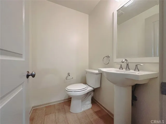a bathroom with a sink toilet and a mirror