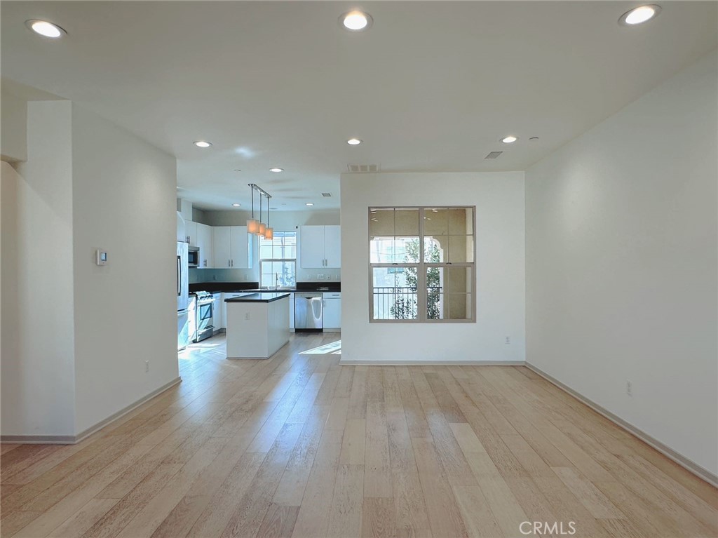 87 Evening Sun Irvine, CA 92620 - Photo 7 of 20 a view of kitchen with a sink wooden floor and a kitchen