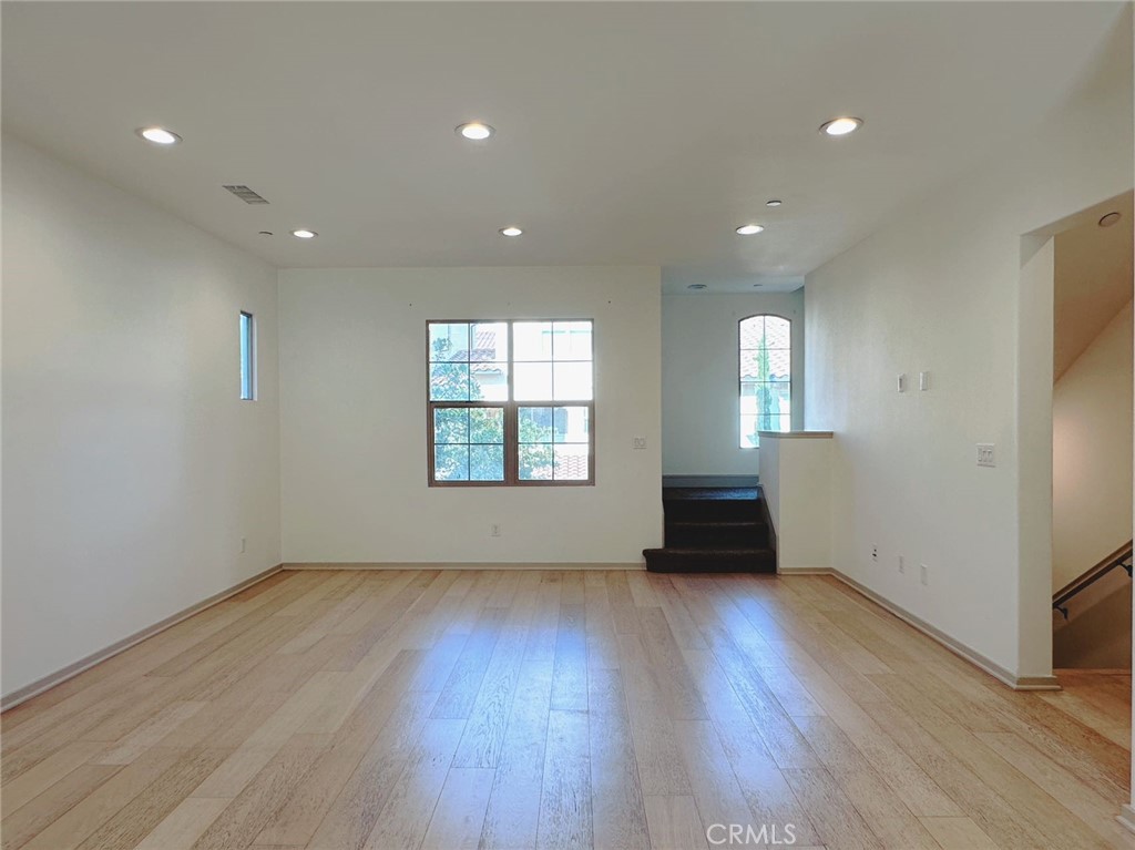 87 Evening Sun Irvine, CA 92620 - Photo 10 of 20 an empty room with wooden floor and windows