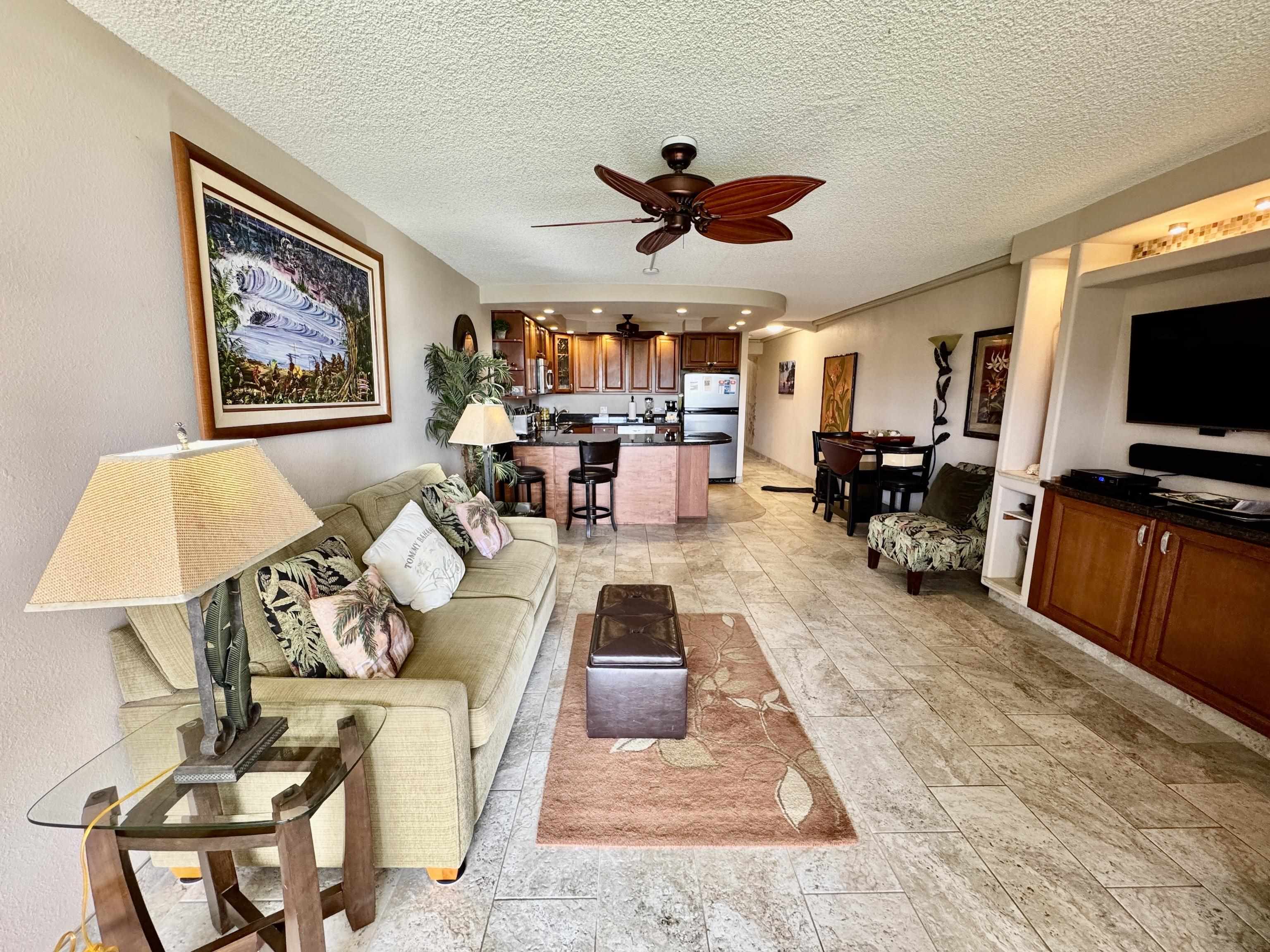 2695 South Kihei Road, Unit 10213 Kihei, HI 96753 - Photo 12 of 37 a living room with furniture ceiling fan and a flat screen tv