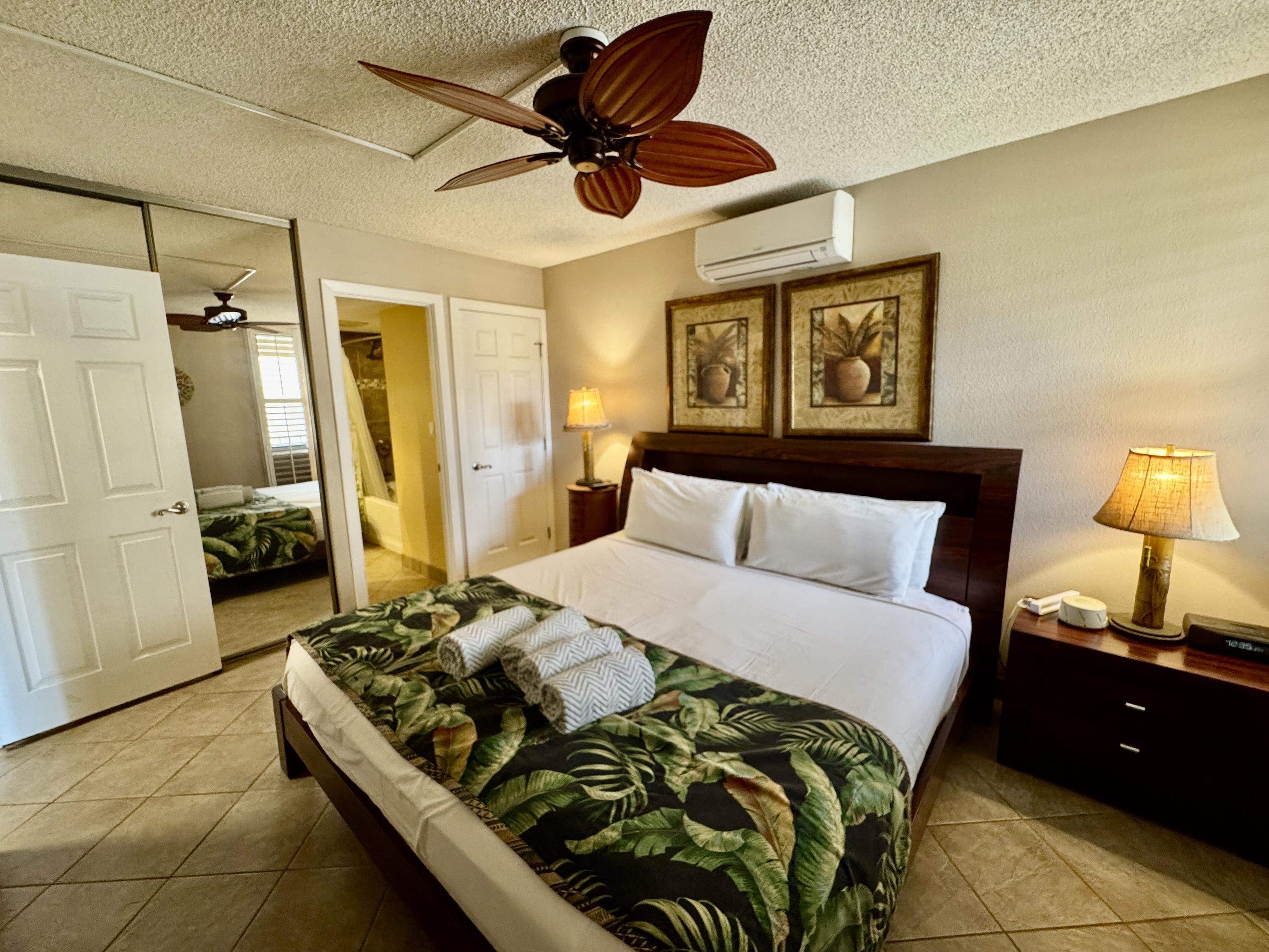 2695 South Kihei Road, Unit 10213 Kihei, HI 96753 - Photo 20 of 37 a bedroom with a bed and a walk in closet