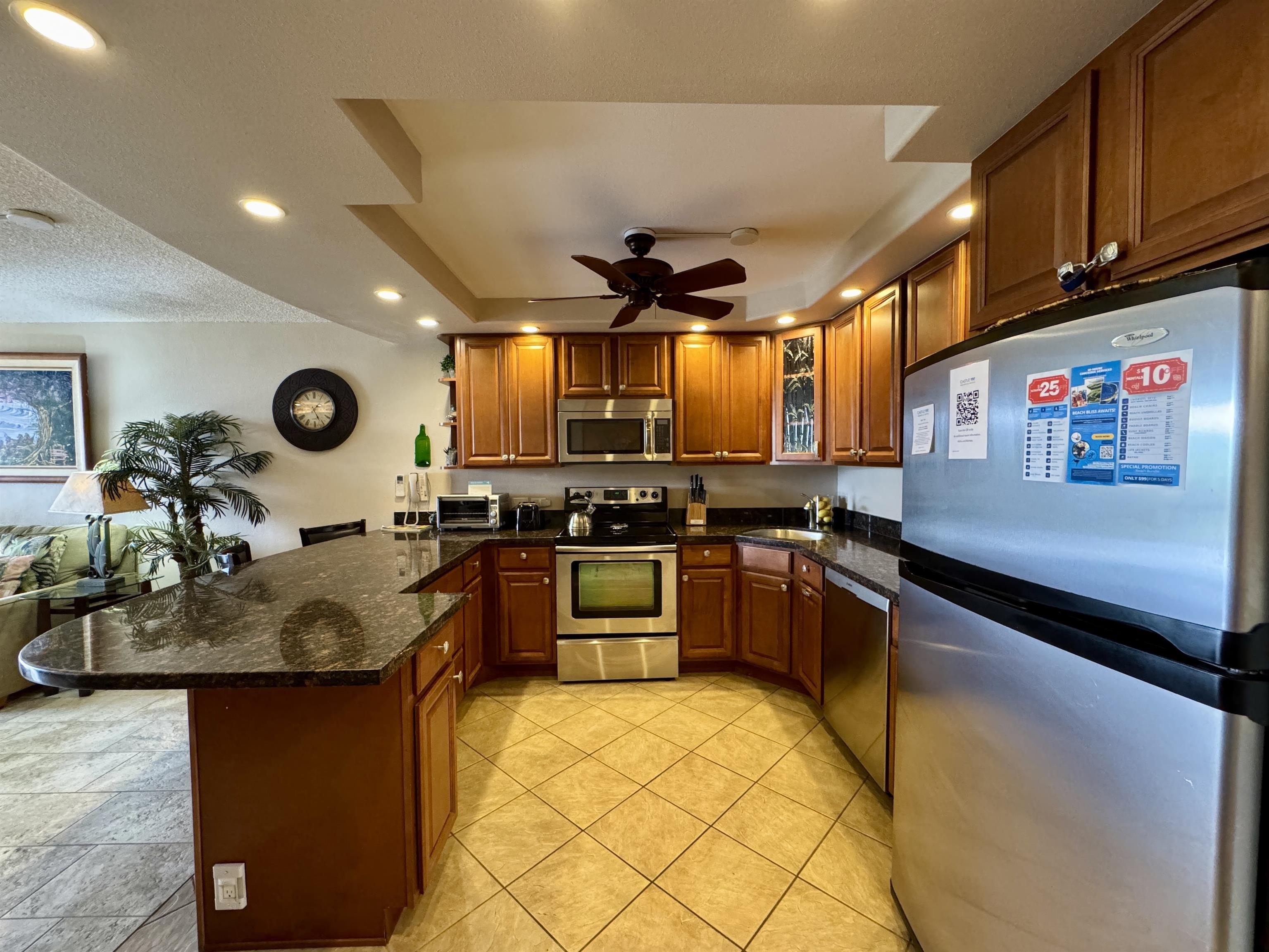 2695 South Kihei Road, Unit 10213 Kihei, HI 96753 - Photo 5 of 37 a kitchen with stainless steel appliances granite countertop a sink a stove and a microwave