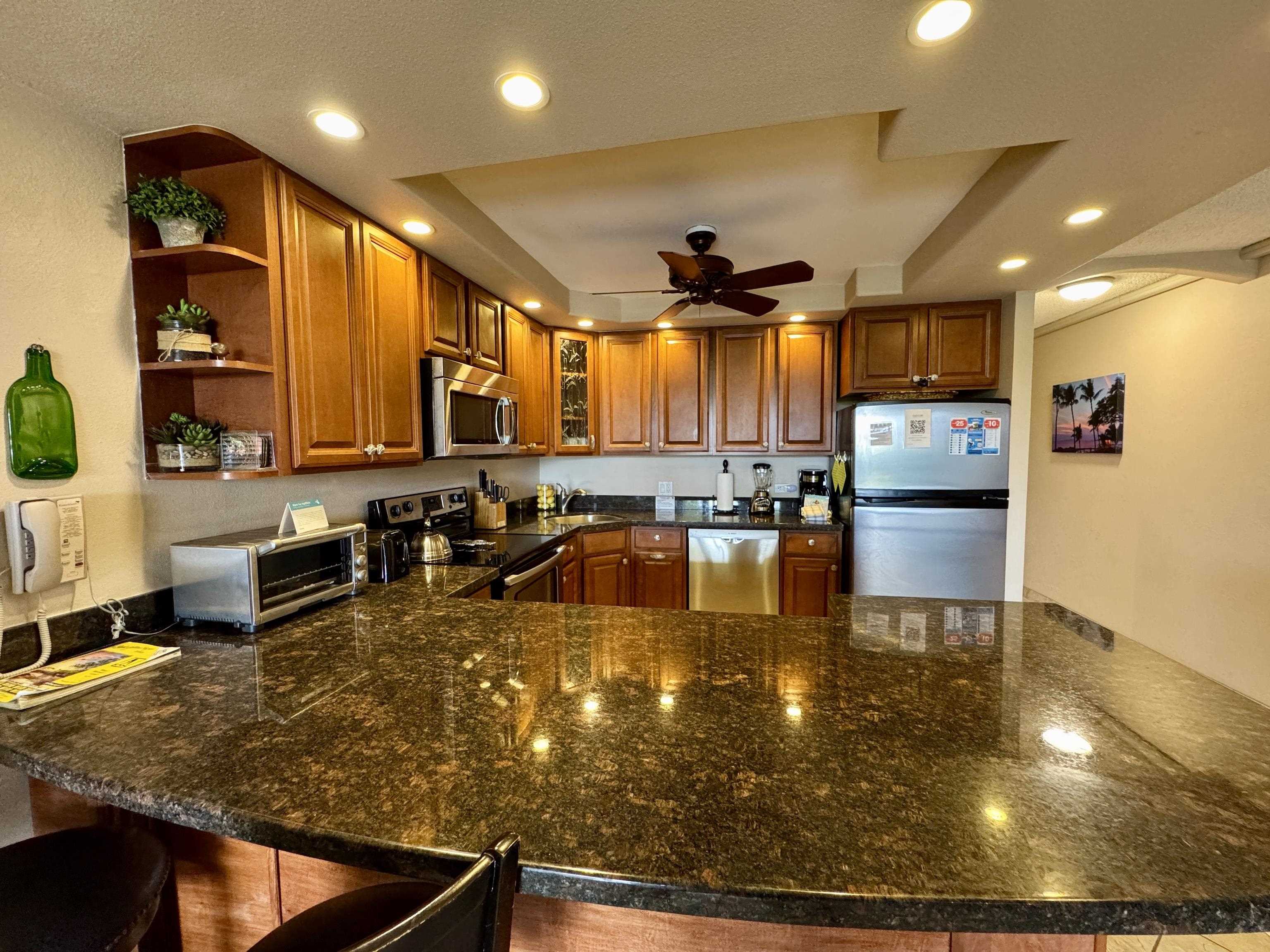2695 South Kihei Road, Unit 10213 Kihei, HI 96753 - Photo 6 of 37 a large kitchen with lots of counter space a sink and appliances