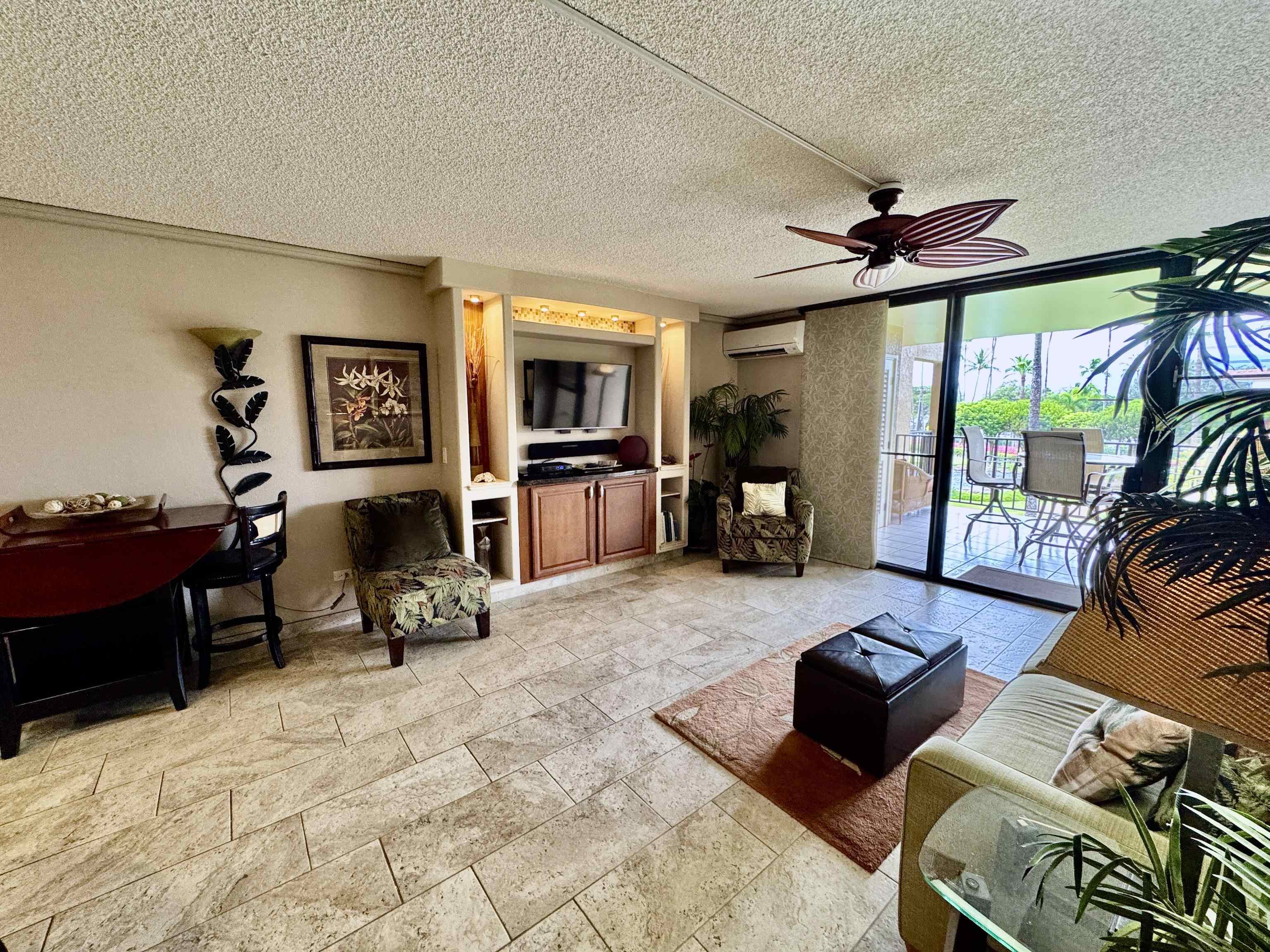 2695 South Kihei Road, Unit 10213 Kihei, HI 96753 - Photo 9 of 37 a living room with furniture and a flat screen tv