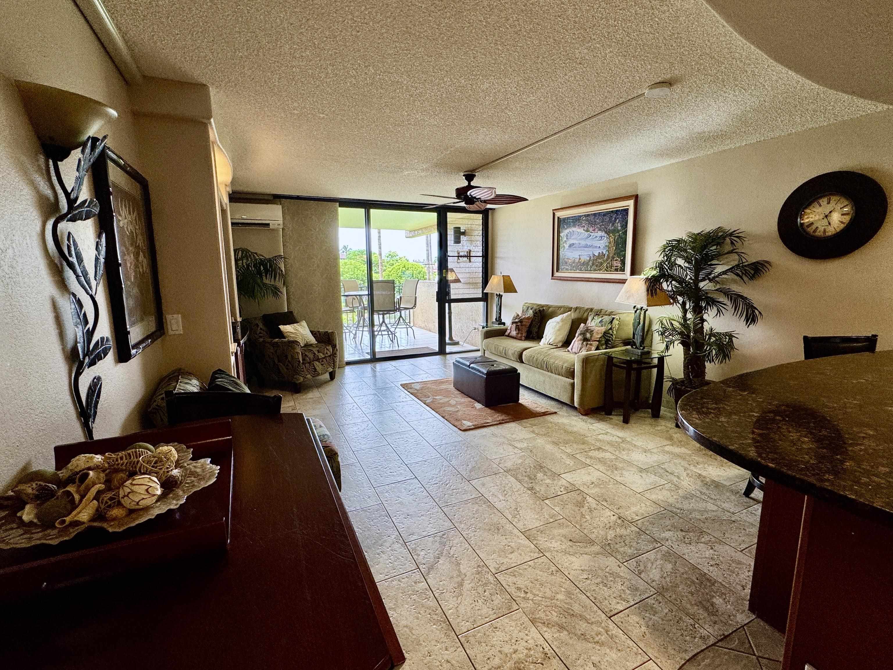 2695 South Kihei Road, Unit 10213 Kihei, HI 96753 - Photo 10 of 37 a living room with furniture rug and a large window