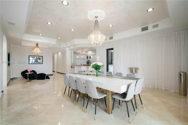a view of a dining room with furniture and chandelier