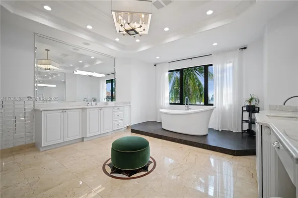a kitchen with a stove a sink and a chandelier