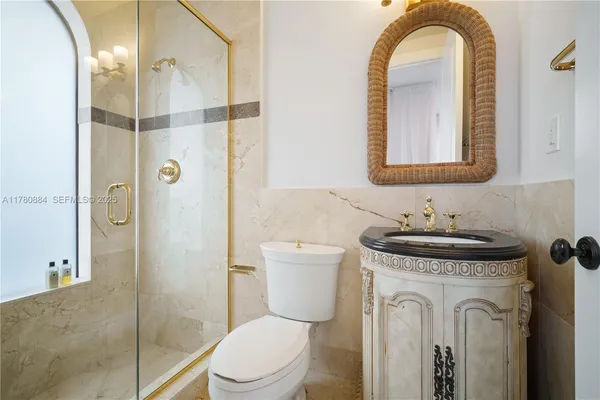 a bathroom with a toilet a sink and glass door