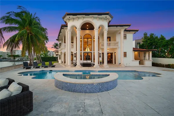 a view of a house with swimming pool and sitting area