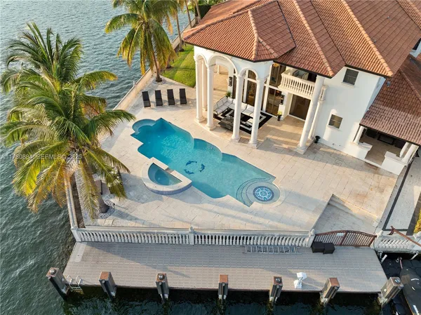 an aerial view of a house with a yard and sitting area