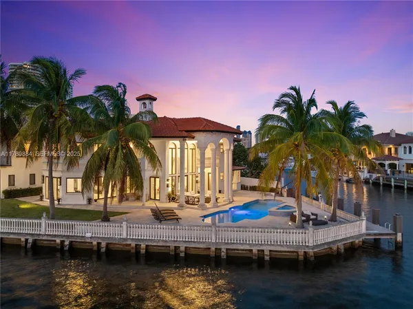 a patio with tables and chairs pool and a fire pit with wooden floor