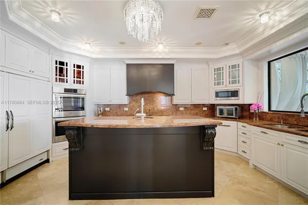 a kitchen with stainless steel appliances granite countertop a sink and cabinets
