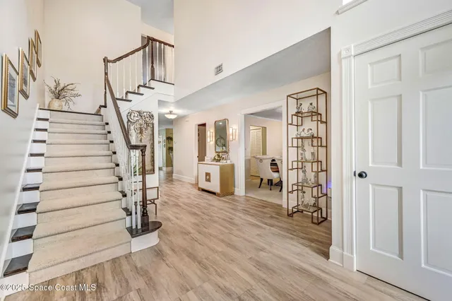 a view of entryway with stairs and wooden floor