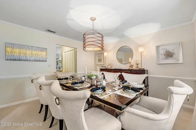 a living room with furniture a large window and a chandelier