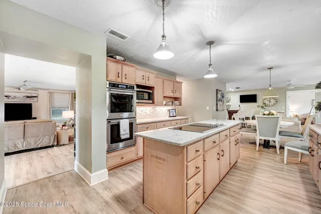 a large kitchen with kitchen island a large island in it