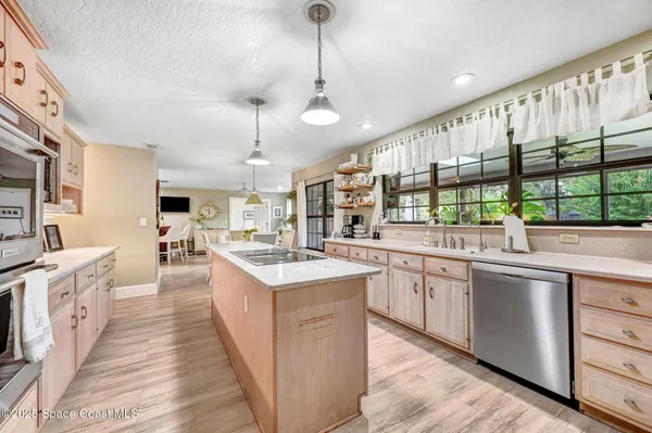 a large kitchen with stainless steel appliances lots of counter space and a sink