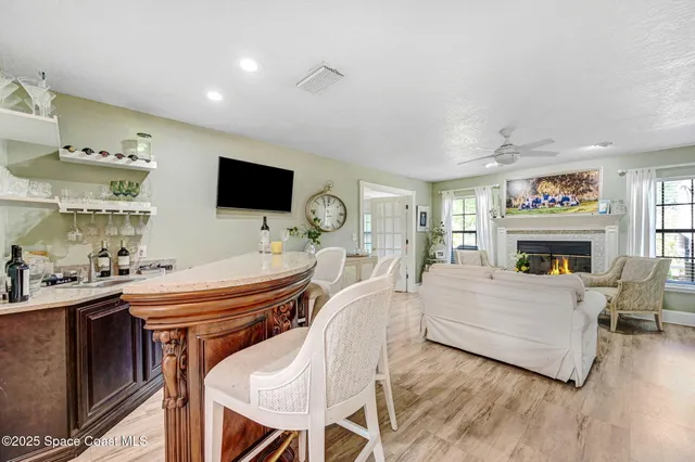 a living room with furniture fireplace and flat screen tv