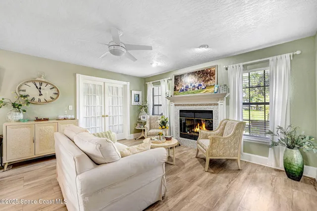 a living room with furniture a fireplace and wooden floor